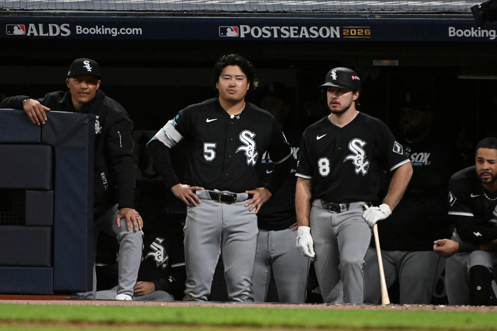 Chicago White Sox first baseman Munetaka Murakami (5) and catcher Kyle Teel (8) watch from the dugout during the eighth inning of Game 5 of baseball's American League Division Series against the Cleveland Guardians, Saturday, Oct. 10, 2026, in Cleveland. (AP Photo/Phil Long)