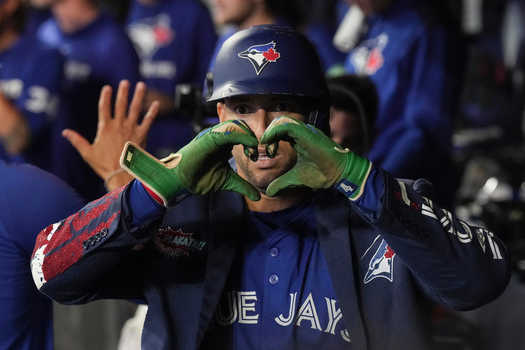 Toronto Blue Jays' George Springer (4) celebrates in the dug out after hitting a two-run home run off Boston Red Sox pitcher Zack Kelly during sixth inning MLB baseball action in Toronto on Thursday September 25, 2025. (Chris Young/The Canadian Press via AP)