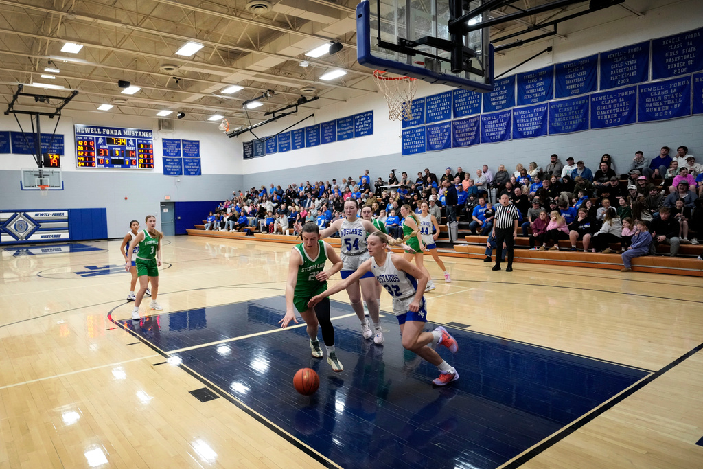 Newell-Fonda's Rylee Hogrefe (32) fights for the ball with Storm Lake's Grace Kinkel (21) during a high school girls basketball game, Jan. 6, 2026, in Newell, Iowa. (AP Photo/Charlie Neibergall)