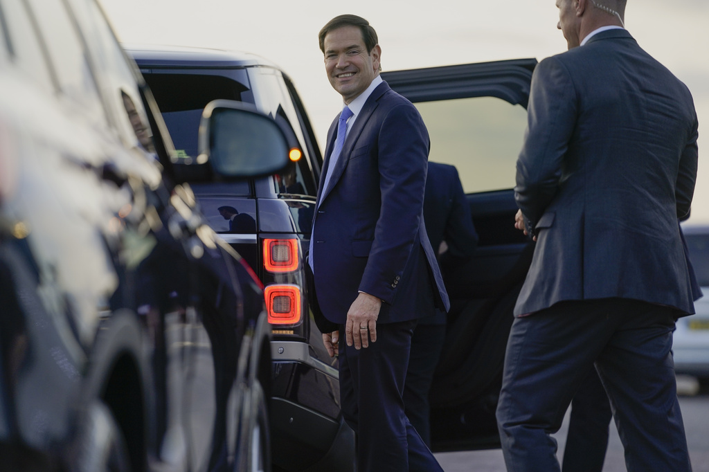 U.S. Secretary of State Marco Rubio smiles as he prepares to enter a vehicle upon arrival at London Stansted Airport, during an official visit near London, Tuesday, Sept. 16, 2025. (Nathan Howard/Pool Photo via AP)
