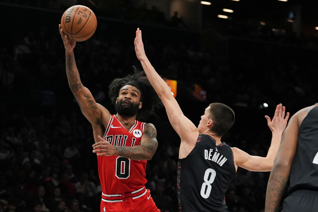 Chicago Bulls' Coby White (0) shoots over Brooklyn Nets' Egor Demin (8) during the first half of an NBA basketball game Friday, Jan. 16, 2026, in New York. (AP Photo/Frank Franklin II)