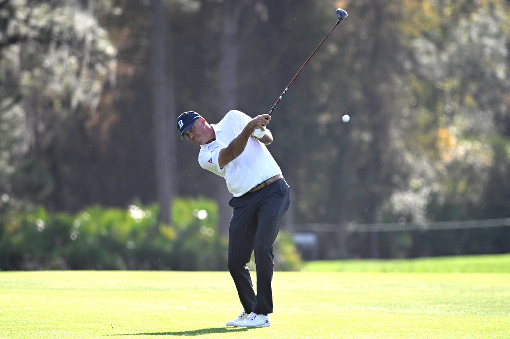 Matt Kuchar hits from the 14th fairway during the final round of the PNC Championship golf tournament, Sunday, Dec. 21, 2025, in Orlando, Fla. (AP Photo/Phelan M. Ebenhack)