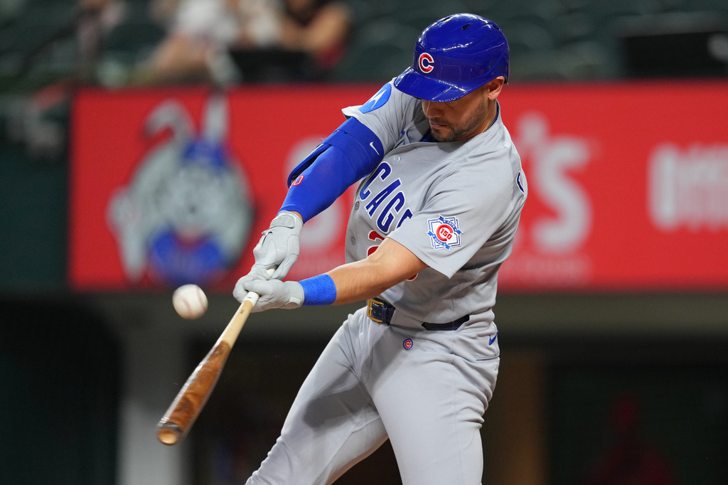 Chicago Cubs designated hitter Michael Conforto connects for a double off Texas Rangers starting pitcher Kumar Rocker during the first inning of a baseball game Friday, May 8, 2026, in Arlington, Texas. (AP Photo/Julio Cortez)