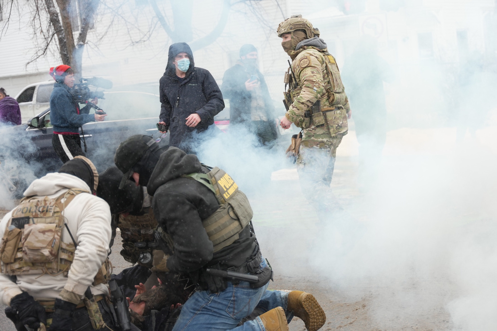 Tear gas is deployed as Federal agents make arrests on Wednesday, Jan. 21, 2026, in Minneapolis. (AP Photo/Angelina Katsanis)