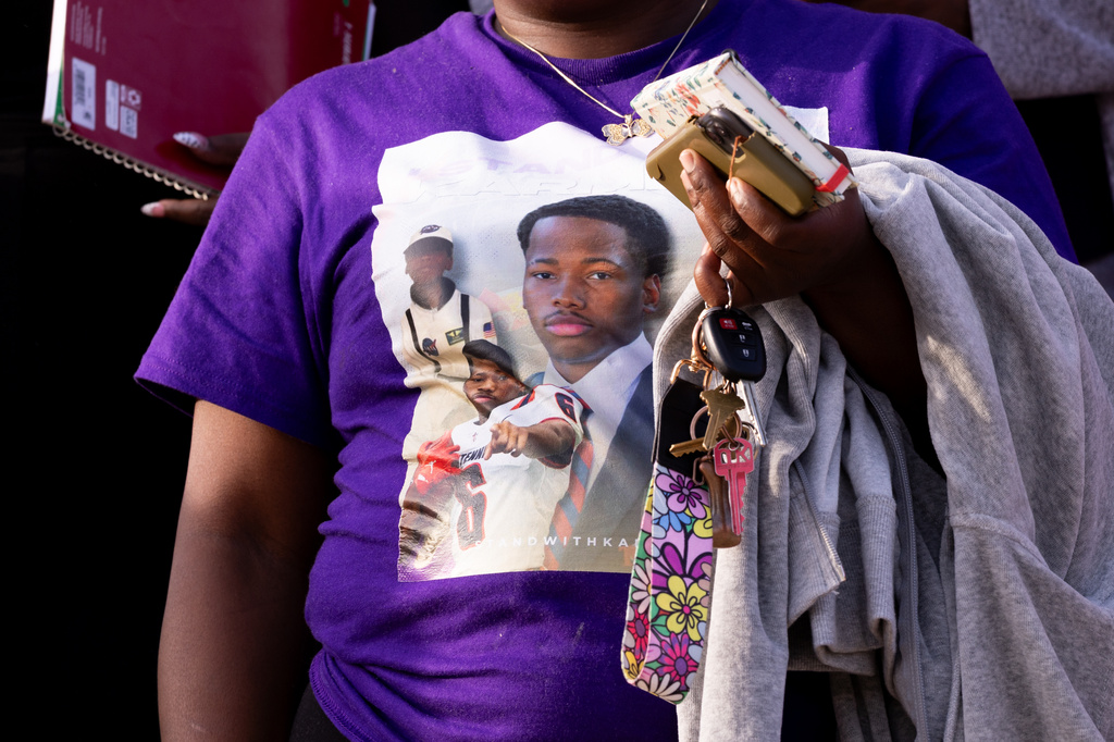 A Karmelo Anthony supporter carries a sign following closing arguments in a hearing on Anthony's motion for a new trial at the Collin County Courthouse in McKinney, Texas, Friday, Aug. 21, 2026. (Juan Figueroa/The Dallas Morning News via AP)