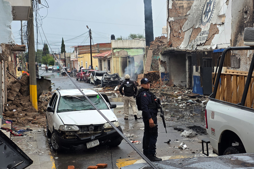 Police stand outside a municipal police station damaged after a car bomb exploded overnight in Ojocaliente, Zacatecas state, Mexico, Monday, Aug. 31, 2026. (AP Photo/Eduardo Pesci)