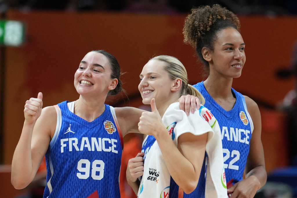 France's Pauline Astier, left, and France's Marine Johannes react after the Women's Basketball World Cup quarterfinal match between the China and France in Berlin, Thursday, Sept. 10, 2026. (AP Photo/Ebrahim Noroozi)