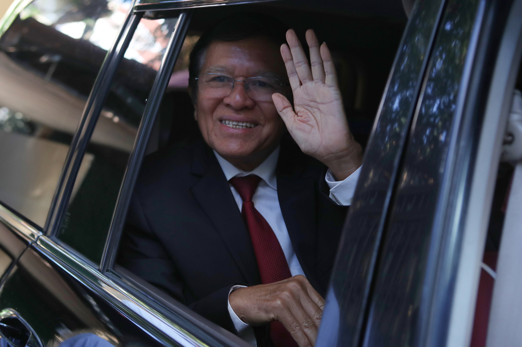 FILE -Former President of Cambodia National Rescue Party, Kem Sokha, greets from his car in front of his house in Phnom Penh, Cambodia, Friday, March 3, 2023. (AP Photo/Heng Sinith, File)