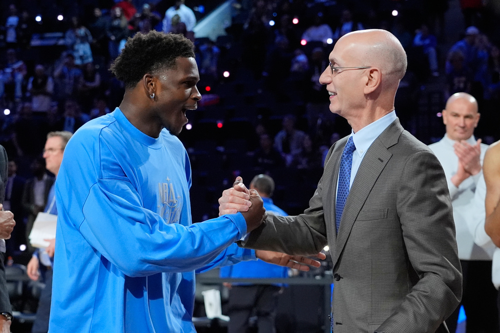 USA Stars guard Anthony Edwards, left, shakes hands with commissioner Adam Silver after the NBA All-Star basketball game Sunday, Feb. 15, 2026, in Inglewood, Calif. (AP Photo/Jae C. Hong)