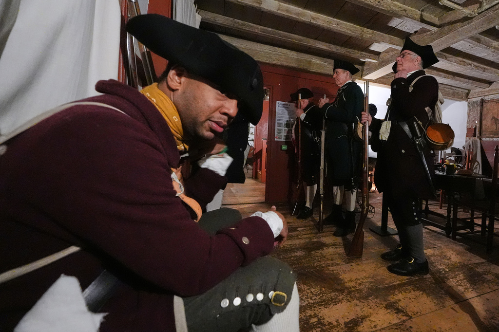 Colonial minute men muster inside the Buckman Tavern prior to a historic re-enactment of the Battle of Lexington, Saturday, April 18, 2026, in Lexington, Mass. (AP Photo/Charles Krupa)