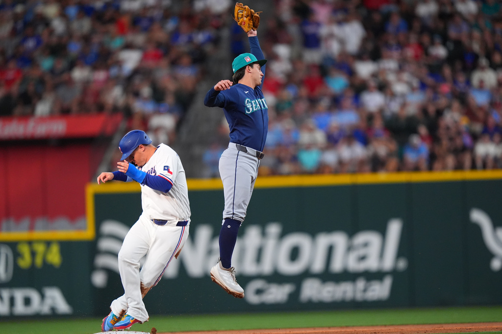 Texas Rangers' Joc Pederson, left, steals second base against Seattle Mariners second baseman Cole Young during the second inning of a baseball game, Saturday, July 25, 2026, in Arlington, Texas. (AP Photo/LM Otero)