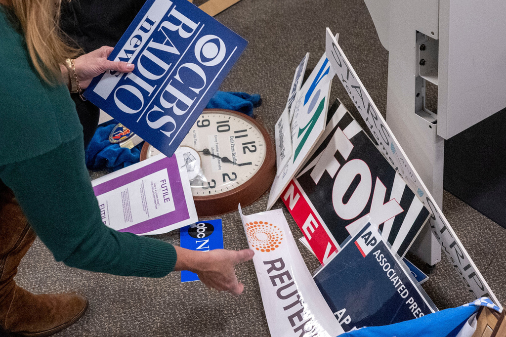 Washington Post reporter Tara Copp saves the name plaques from various news organizations as she and members of the media pack up their belongings in the press area in the Pentagon, Wednesday, Oct. 15, 2025 in Washington. (AP Photo/Kevin Wolf)