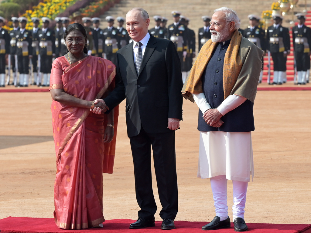 Russian President Vladimir Putin, center, shakes hands with Indian President Droupadi Murmu as Indian Prime Minister Narendra Modi, right, looks on during a ceremonial reception at the Rashtrapati Bhavan in New Delhi, India, Friday, Dec. 5, 2025. (AP Photo)