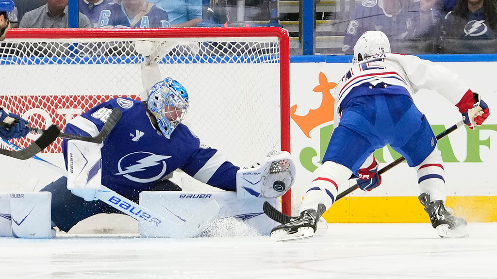 Tampa Bay Lightning goaltender Andrei Vasilevskiy (88) makes a glove save on a shot by Montréal Canadiens center Alex Newhook (15) during the second period in Game 5 of an NHL hockey Stanley Cup first-round playoff series, Wednesday, April 29, 2026, in Tampa, Fla. (AP Photo/Chris O'Meara)