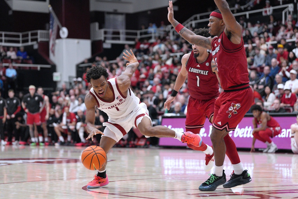 Stanford guard Ebuka Okorie (1) drives to th basket against Louisville guard Ryan Conwell (3) during the second half of an NCAA college basketball game in Stanford, Calif., Friday, Jan. 2, 2026. (AP Photo/Tony Avelar)