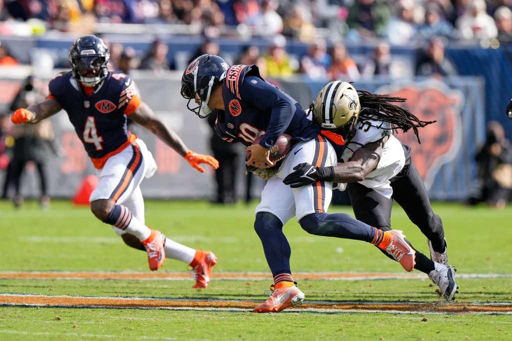 New Orleans Saints outside linebacker Demario Davis (56) tackles Chicago Bears quarterback Caleb Williams in the second half of an NFL football game, Sunday, Oct. 19, 2025, in Chicago. (AP Photo/Nam Huh)