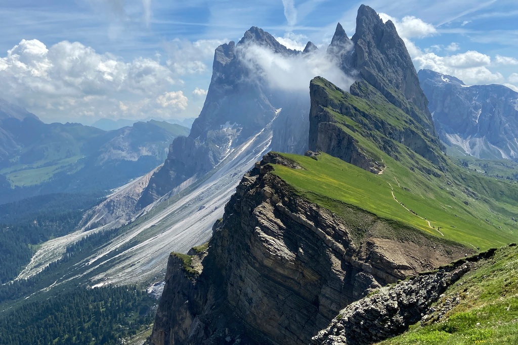 FILE- Clouds hang over the 'Seceda' Dolomites mountain, 2519 meters, near Ortisei val Gardena, (St. Ulrich in Groeden) in northern Italian province of South Tyrol, Italy, June 28, 2021. (AP Photo/Matthias Schrader, File)