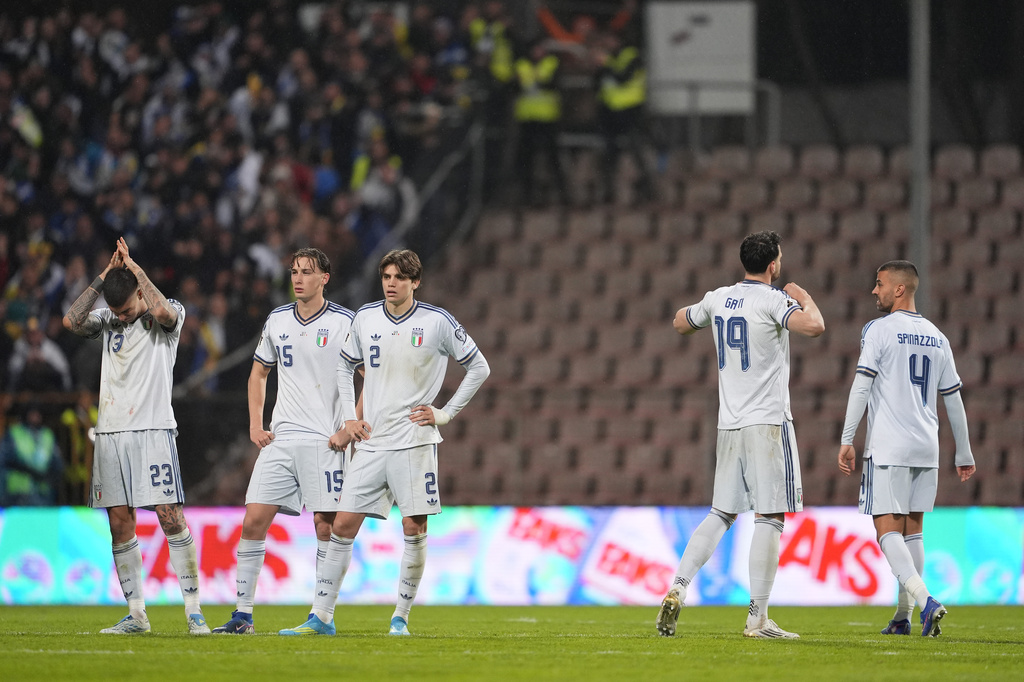 Italy players react after losing in a World Cup qualifying playoff final soccer match between Bosnia and Italy in Zenica, Bosnia, Tuesday, March 31, 2026. (Fabio Ferrari/LaPresse via AP)