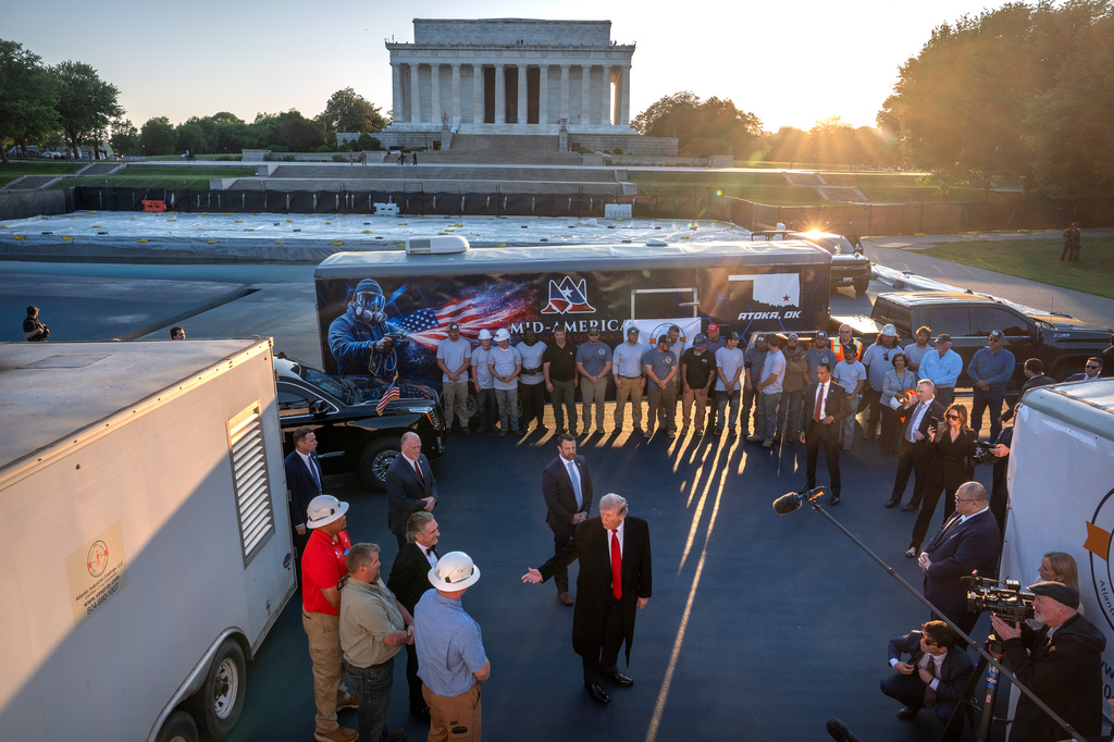 President Donald Trump talks as he visits the Lincoln Memorial Reflecting Pool to see the new blue protective coating being applied as part of a renovation project, Thursday, May 7, 2026, in Washington. (AP Photo/Mark Schiefelbein)