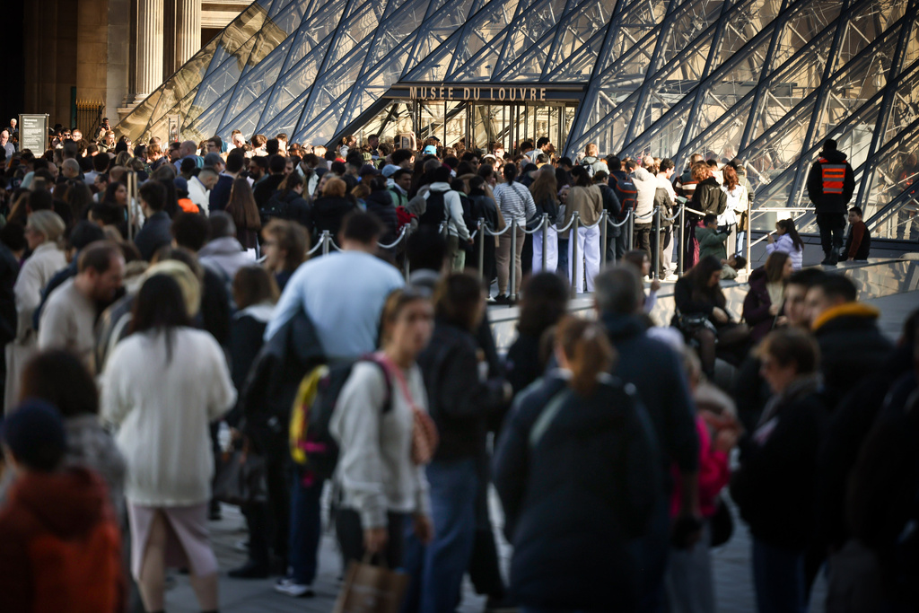 People queue to enter the Louvre museum in Paris, Wednesday Feb. 25. 2026. (AP Photo/Thomas Padilla)