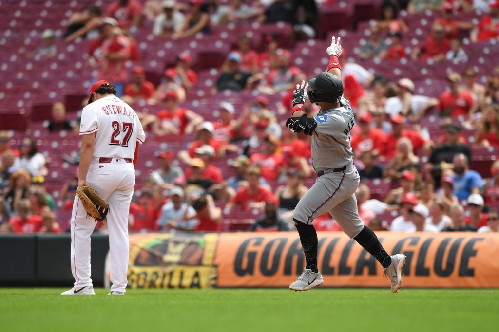 Miami Marlins' Heriberto Hernández, right, rounds the bases after hitting a solo home run during the eighth inning of a baseball game against the Cincinnati Reds, Sunday, Aug. 16, 2026, in Cincinnati. (AP Photo/Tanner Pearson)