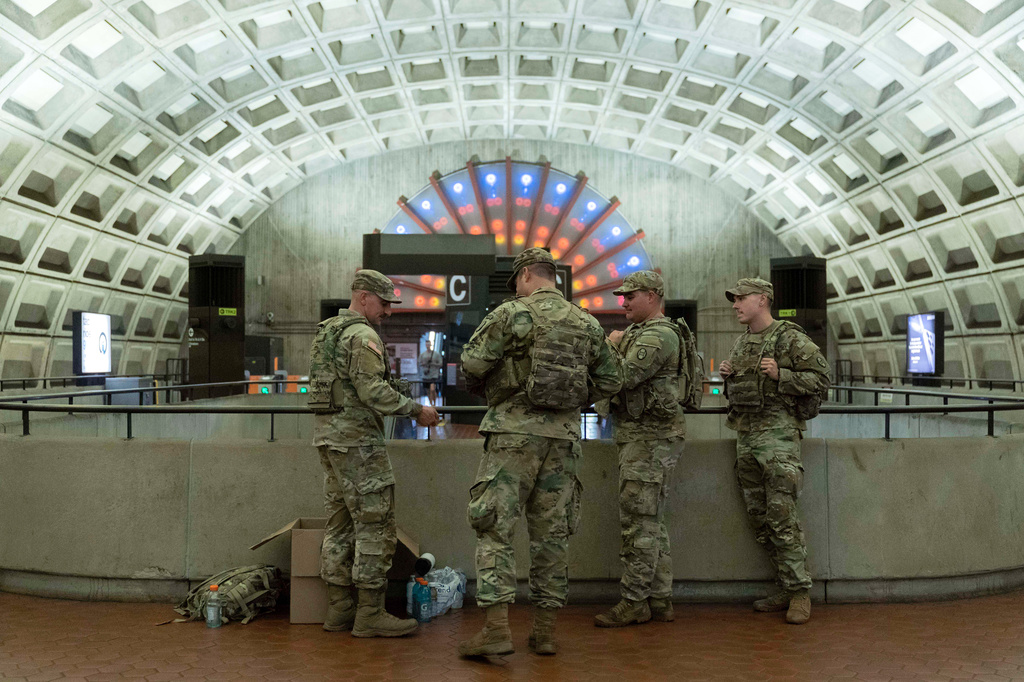 Members of the District of Columbia National Guard patrol Chinatown metro station in downtown Washington, Friday, Aug. 22, 2025. (AP Photo/Jose Luis Magana)