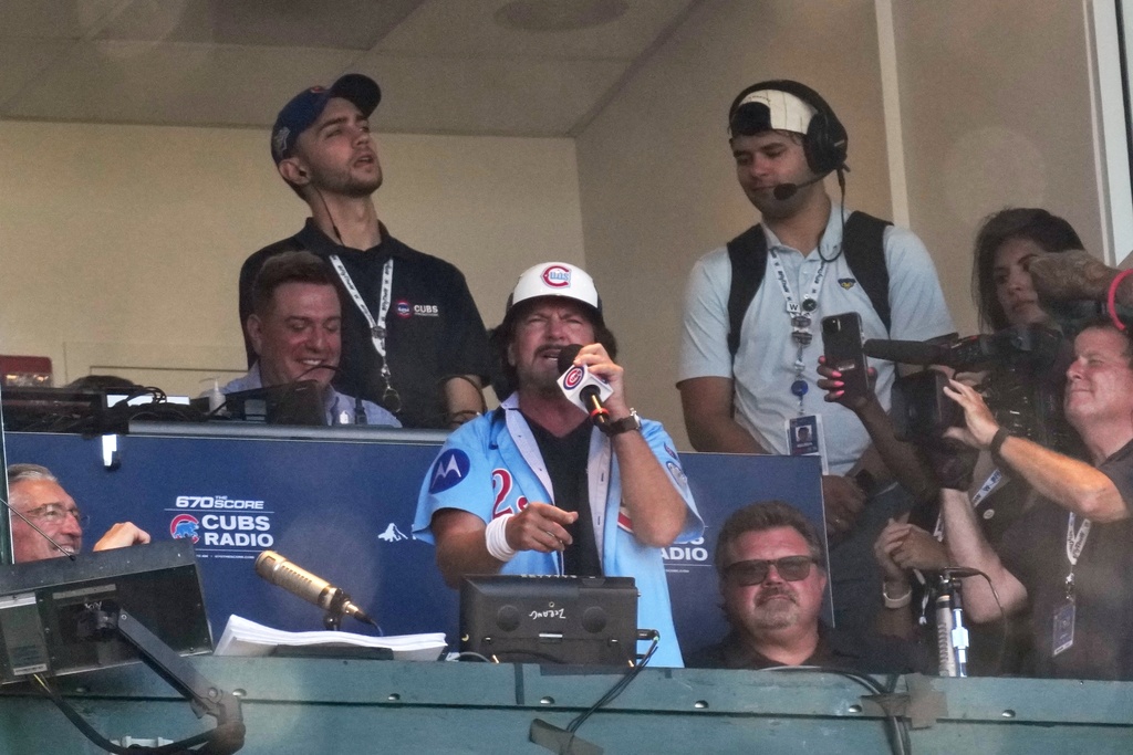 Eddie Vedder sings "Take Me Out to the Ballgame" during the seventh inning of Game 1 of a National League wild card baseball game Tuesday, Sept. 30, 2025, in Chicago. (AP Photo/Nam Huh)