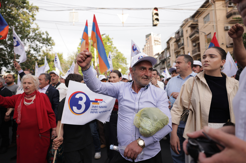A man gestures as he and other supporters of Russian-Armenian tycoon Samvel Karapetyan, who heads Strong Armenia party, has faced criminal charges that he rejected as politically driven and campaigned from under house arrest, rally toward Republic Square against incumbent Prime Minister Nikol Pashinyan in Yerevan, Armenia, Wednesday, June 3, 2026. (AP Photo/Anthony Pizzoferrato)