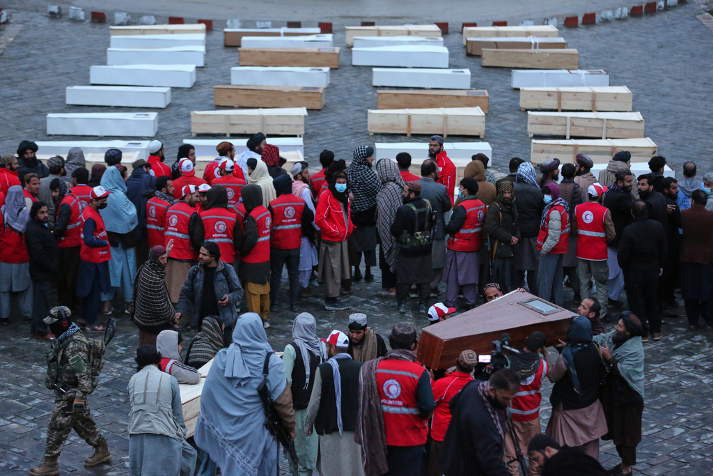 Coffins containing the remains of victims of a Monday airstrike on a drug rehabilitation hospital are laid out before burial in Kabul, Afghanistan, Wednesday, March 18, 2026. (AP Photo/Siddiqullah Alizai)