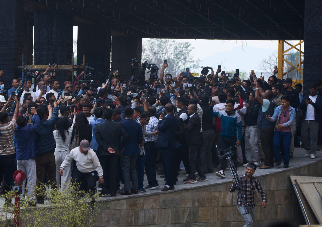 Journalists crowd around Balendra Shah as he arrives for a swearing-in ceremony of newly elected members of the House of Representatives at the Federal Parliament in Kathmandu, Nepal, Thursday, March 26, 2026. (AP Photo/Niranjan Shrestha)