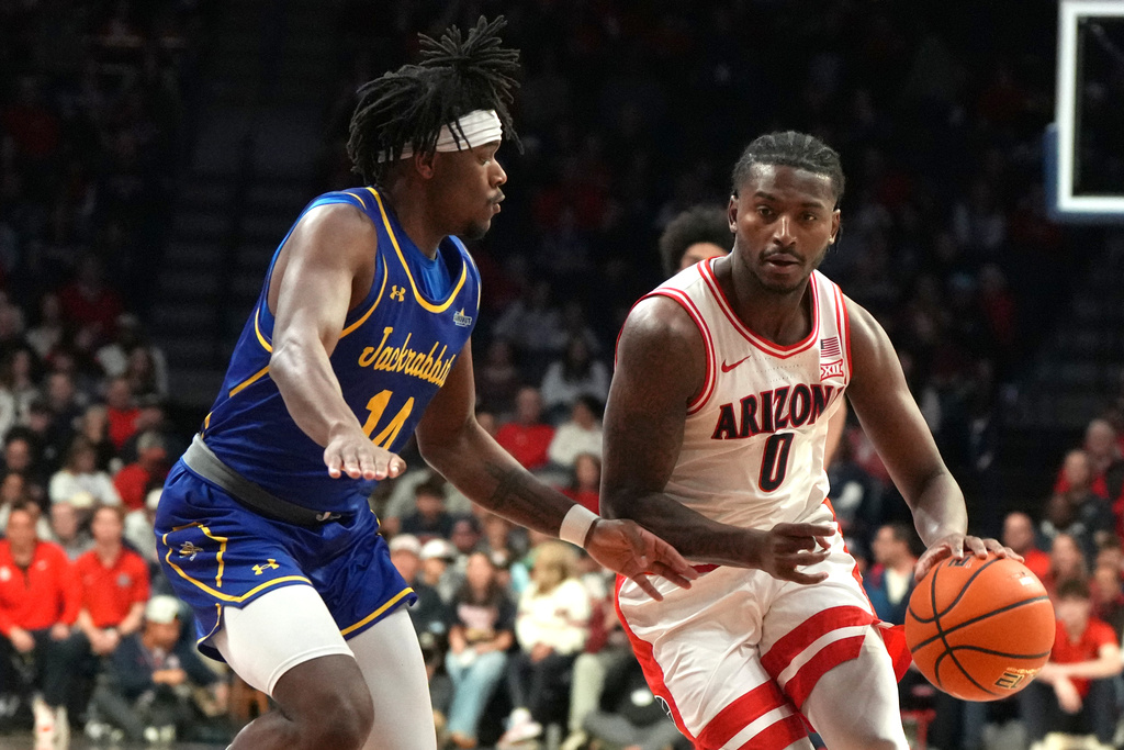 Arizona guard Jaden Bradley drives on South Dakota State guard Jaden Jackson (14) during the first half of an NCAA college basketball game, Monday, Dec. 29, 2025, in Tucson, Ariz. (AP Photo/Rick Scuteri)