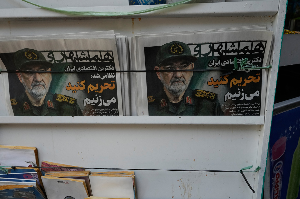 The Iranian newspaper Hamshahri is displayed at a newsstand with headline in Farsi: "Iran's economic doctrine became militarized," and an image of the country's Supreme National Security Council secretary Mohsen Rezaei in downtown Tehran, Iran, Monday, Aug. 24, 2026. (AP Photo/Vahid Salemi)