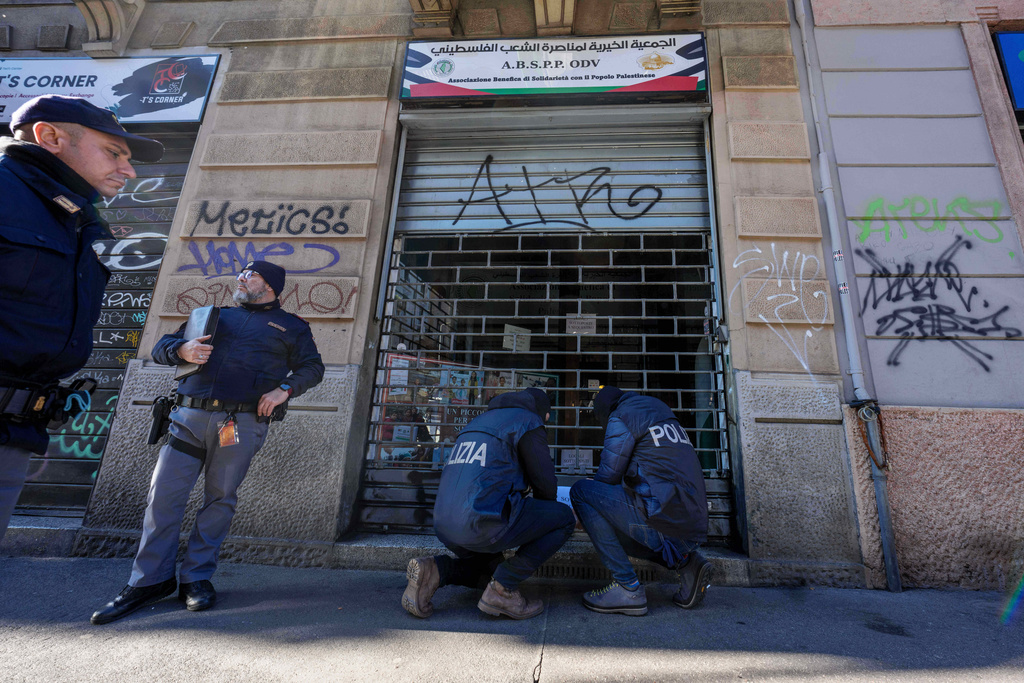Police officers inspect a charitable association supporting Palestinian civilians in Milan, Italy, Saturday, Dec. 27, 2025 after Italian investigators have arrested nine people suspected of raising millions of euros for Hamas. (Claudio Furlan/LaPresse via AP)