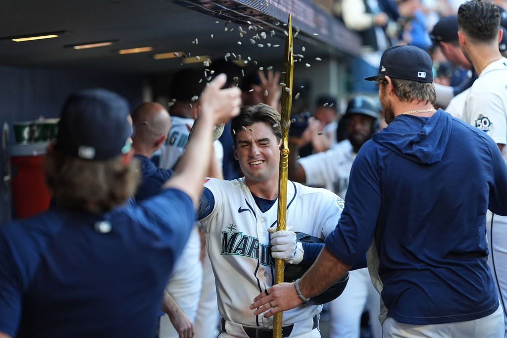 Seattle Mariners relief pitcher Bryce Miller throws seeds at Cole Young as Young celebrates his three-run home run against the San Francisco Giants during the seventh inning of a baseball game, Saturday, July 18, 2026, in Seattle. (AP Photo/Lindsey Wasson)