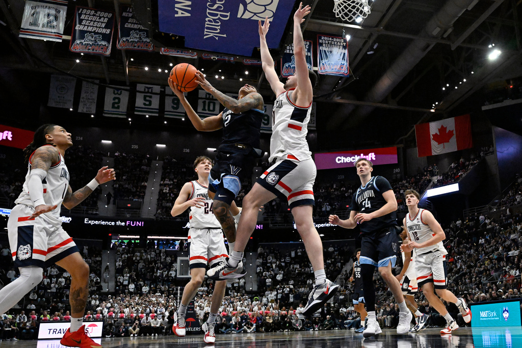 Villanova guard Bryce Lindsay (2) shoots as UConn forward Alex Karaban defends in the first half of an NCAA college basketball game, Saturday, Jan. 24, 2026, in Hartford, Conn. (AP Photo/Jessica Hill)