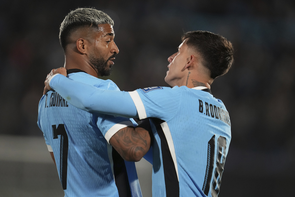 Uruguay's Rodrigo Aguirre, left, celebrates after scoring the opening goal against Peru uring a World Cup 2026 qualifying soccer match in Montevideo, Uruguay, Thursday, Sept. 4, 2025. (AP Photo/Matilde Campodonico)