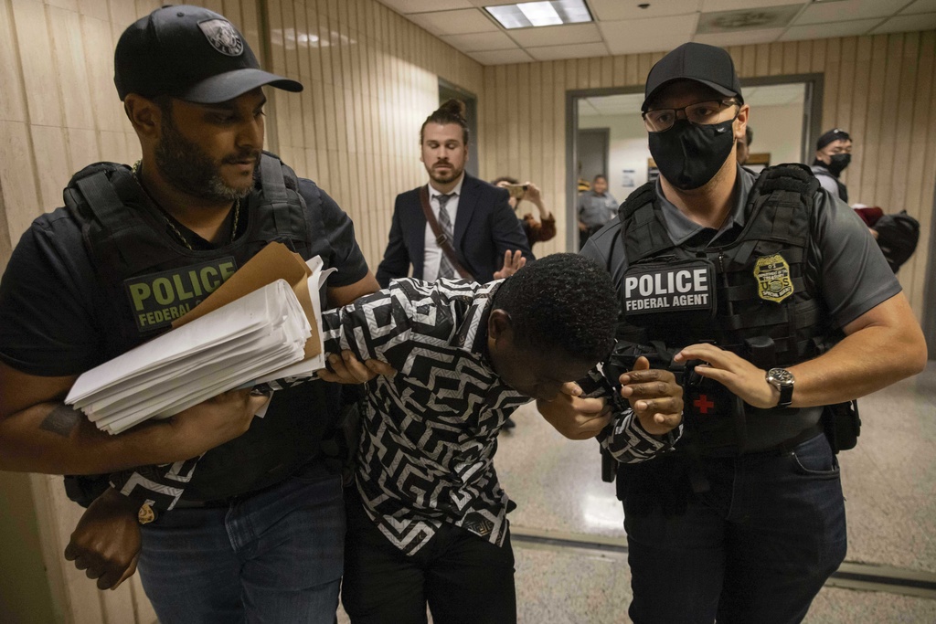 FILE - Federal agents including Immigration and Customs Enforcement detain a person outside an immigration courtroom at the Jacob K. Javits Federal Building in New York, Tuesday, June 10, 2025. (AP Photo/Yuki Iwamura, File)
