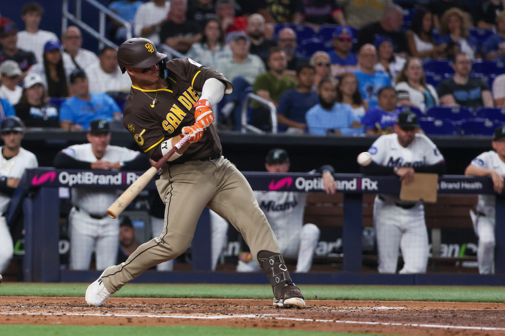 San Diego Padres' Ty France hits a two-run single against the Miami Marlins during the third inning of a baseball game, Saturday, July 25, 2026, in Miami. (AP Photo/David Santiago)