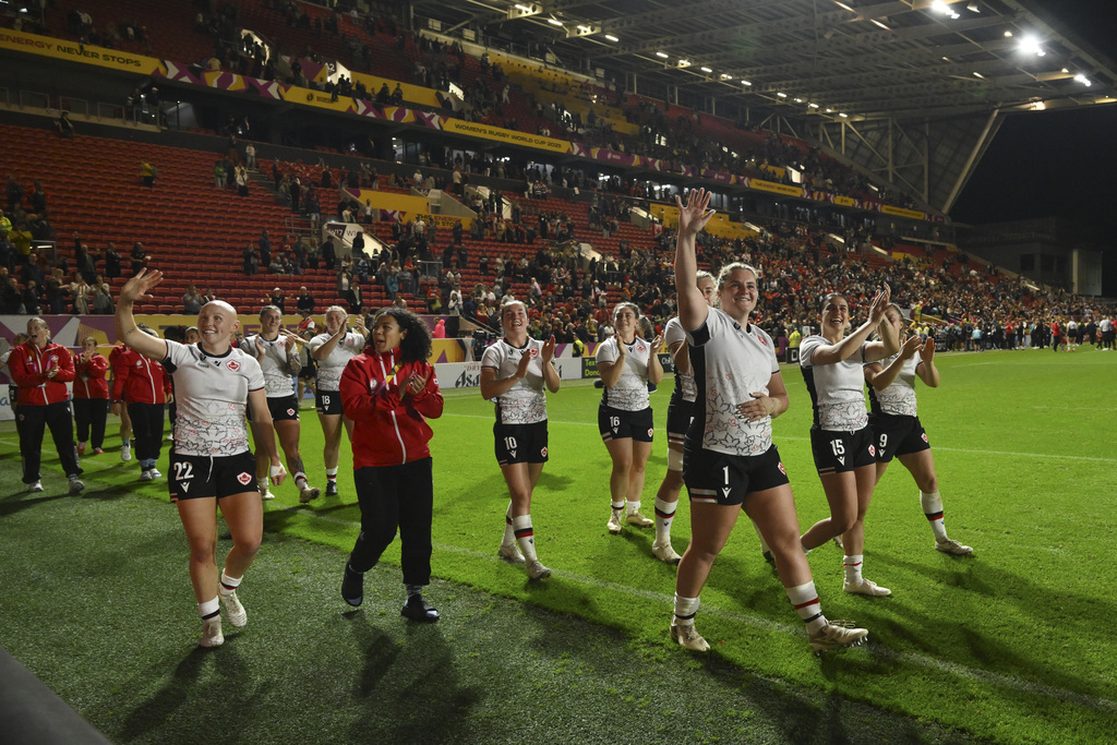 Canada's team players celebrate after winning the Women's Rugby World Cup 2025 semifinal match between New Zealand and Canada in Bristol, England, Friday, Sept. 19, 2025.(AP Photo/Anthony Upton)