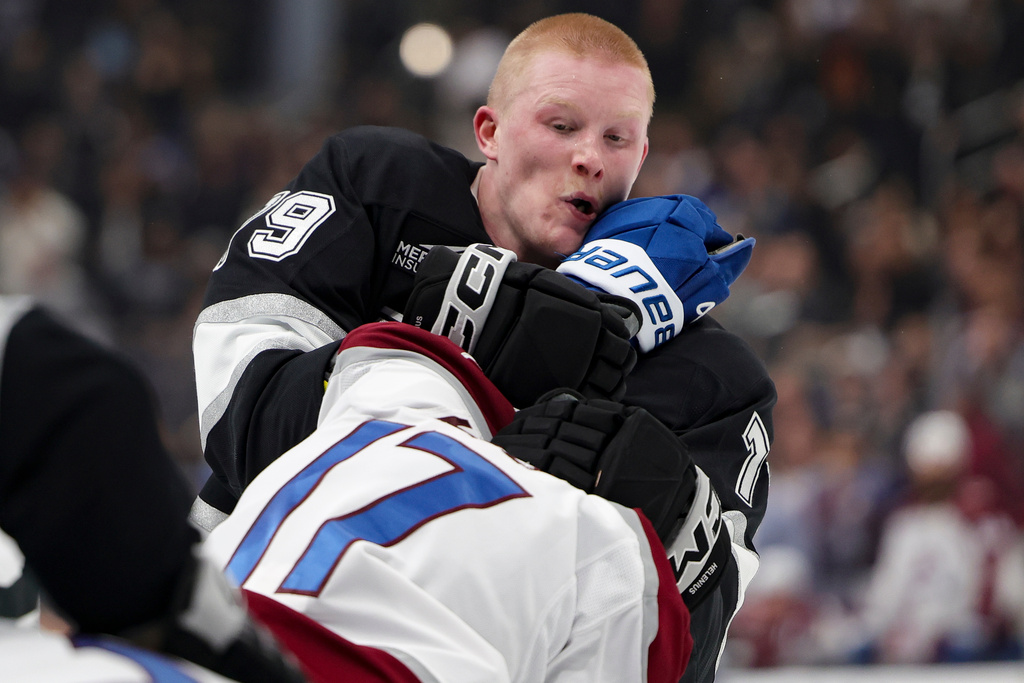Los Angeles Kings center Samuel Helenius, top, and Colorado Avalanche center Parker Kelly fight during the second period of an NHL hockey game Monday, March 2, 2026 in Los Angeles. (AP Photo/Ryan Sun)
