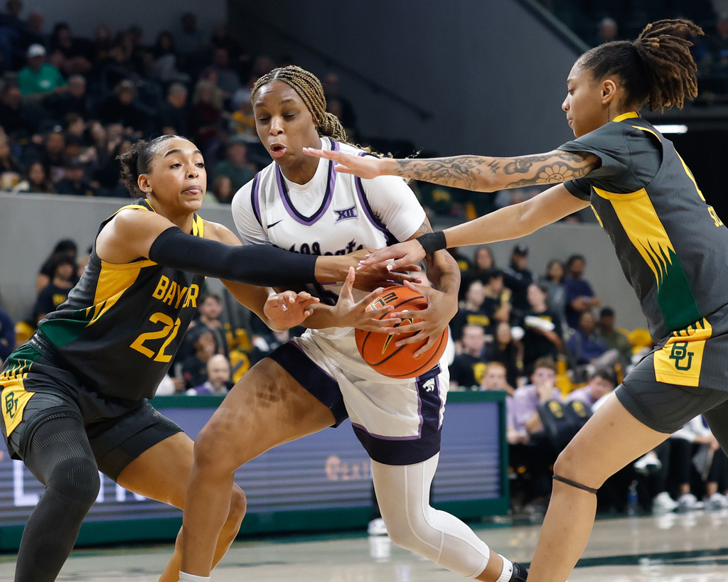Kansas State guard Aniya' Foy, center, loses control of the ball between Baylor forward Bella Fontleroy, left, and guard Taliah Scott, right, in the first half of an NCAA college basketball game, Monday, Feb. 23, 2026, in Waco, Texas. (Chris Jones/Waco Tribune-Herald via AP)