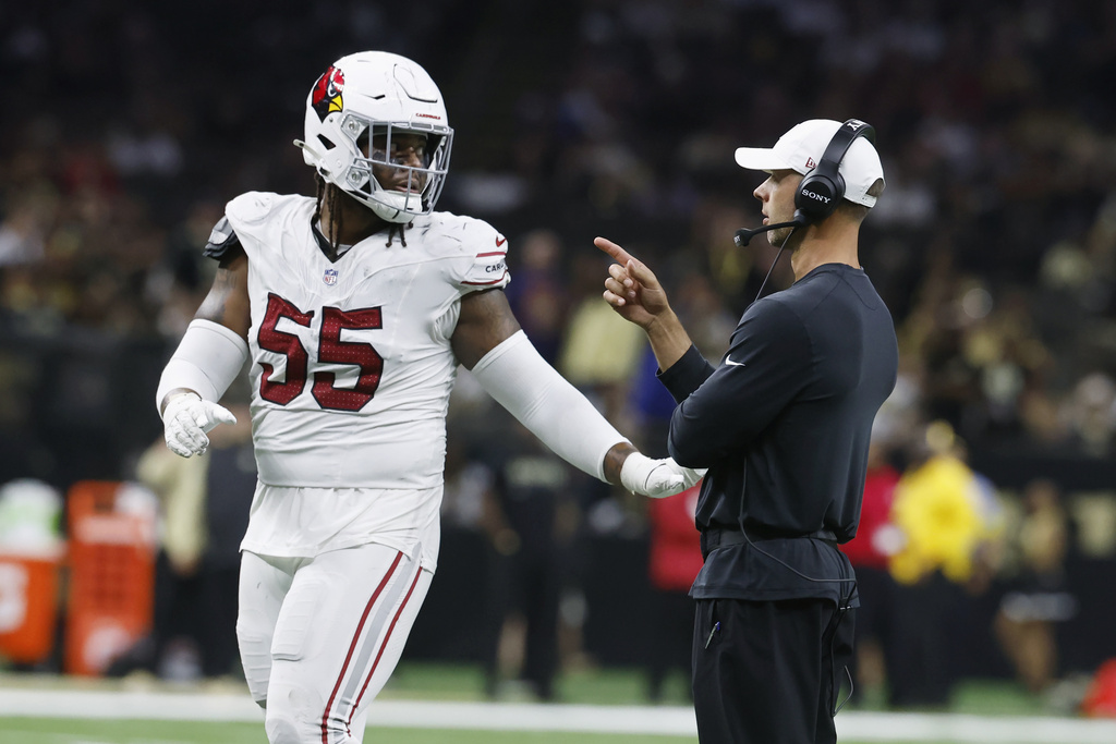 Arizona Cardinals head coach Jonathan Gannon, right, talks with Cardinals defensive tackle Dante Stills (55) during the second half of an NFL football game against the New Orleans Saints Sunday, Sept. 7, 2025, in New Orleans. (AP Photo/Butch Dill)