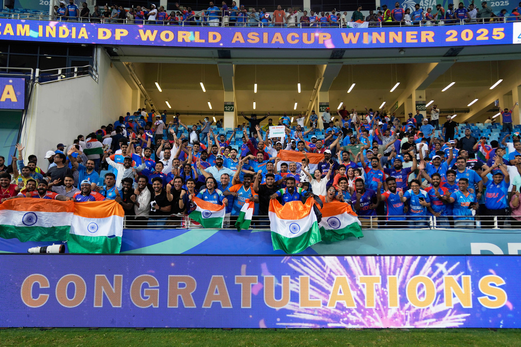 Fans celebrate after India won the Asia Cup cricket final against Pakistan at Dubai International Cricket Stadium, United Arab Emirates, Sunday, Sept. 28, 2025. (AP Photo/Altaf Qadri)