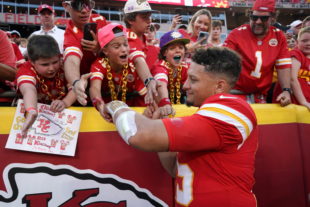 Kansas City Chiefs quarterback Patrick Mahomes (15) shakes hands with fans following an NFL football game against the Baltimore Ravens Sunday, Sept. 28, 2025, in Kansas City, Mo. (AP Photo/Ed Zurga)