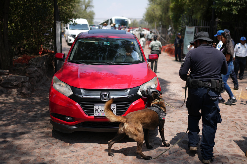 Police inspect vehicles at the Teotihuacan pyramids after the archaeological site reopened two days after a gunman opened fire, killing a Canadian tourist, outside Mexico City, Wednesday, April 22, 2026.