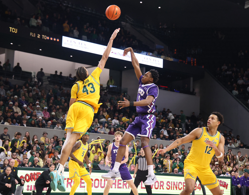 TCU guard Jayden Pierre shoots over Baylor guard Cameron Carr, left, and guard Michael Rataj, right, in the first half of an NCAA college basketball game, Saturday, Jan. 24, 2026, in Waco, Texas. (Rod Aydelotte/Waco Tribune-Herald, via AP)