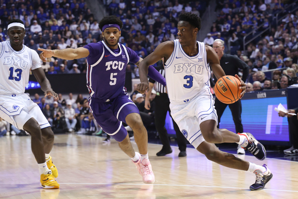 BYU forward AJ Dybantsa (3) drives to the basket against TCU forward Micah Robinson (5) during the first half of an NCAA basketball game, Wednesday, Jan. 14, 2026, in Provo, Utah. (AP Photo/Rob Gray)