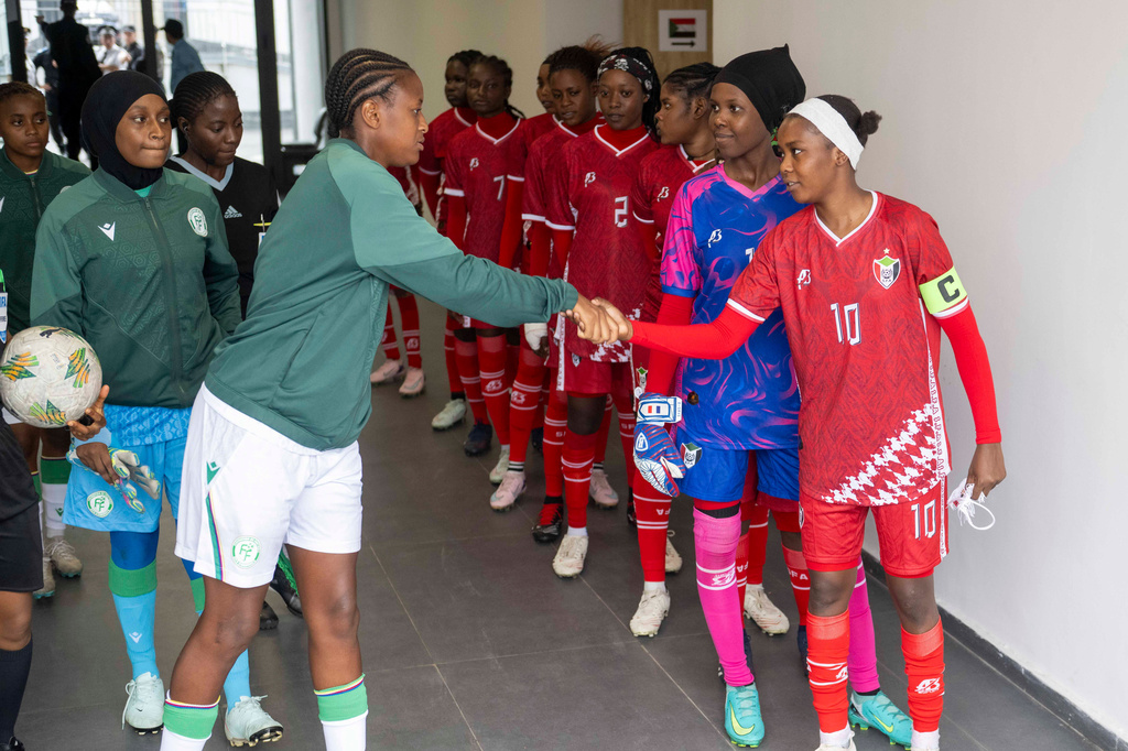 Sudan's U-17 women's national team, left, shakes hand with Comorros women's national team, ahead of their soccer match during qualifiers for the 2028 Los Angeles Summer Olympics, in Casablanca, Morocco, Monday, June 8, 2026. (AP Photo)