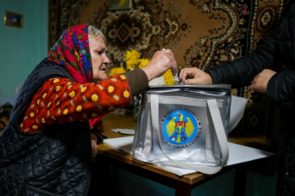 FILE - A woman casts her vote in a mobile ballot box during a presidential election runoff, in the village of Ciopleni, Moldova, Sunday, Nov. 3, 2024. (AP Photo/Vadim Ghirda, File)
