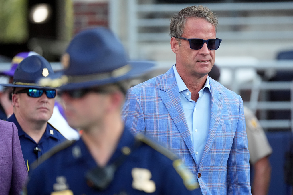 LSU football coach Lane Kiffin follows his protection detail of Louisiana State Police prior to an NCAA college football game against Mississippi in Oxford, Miss., Saturday, Sept. 19, 2026. (AP Photo/Rogelio V. Solis)